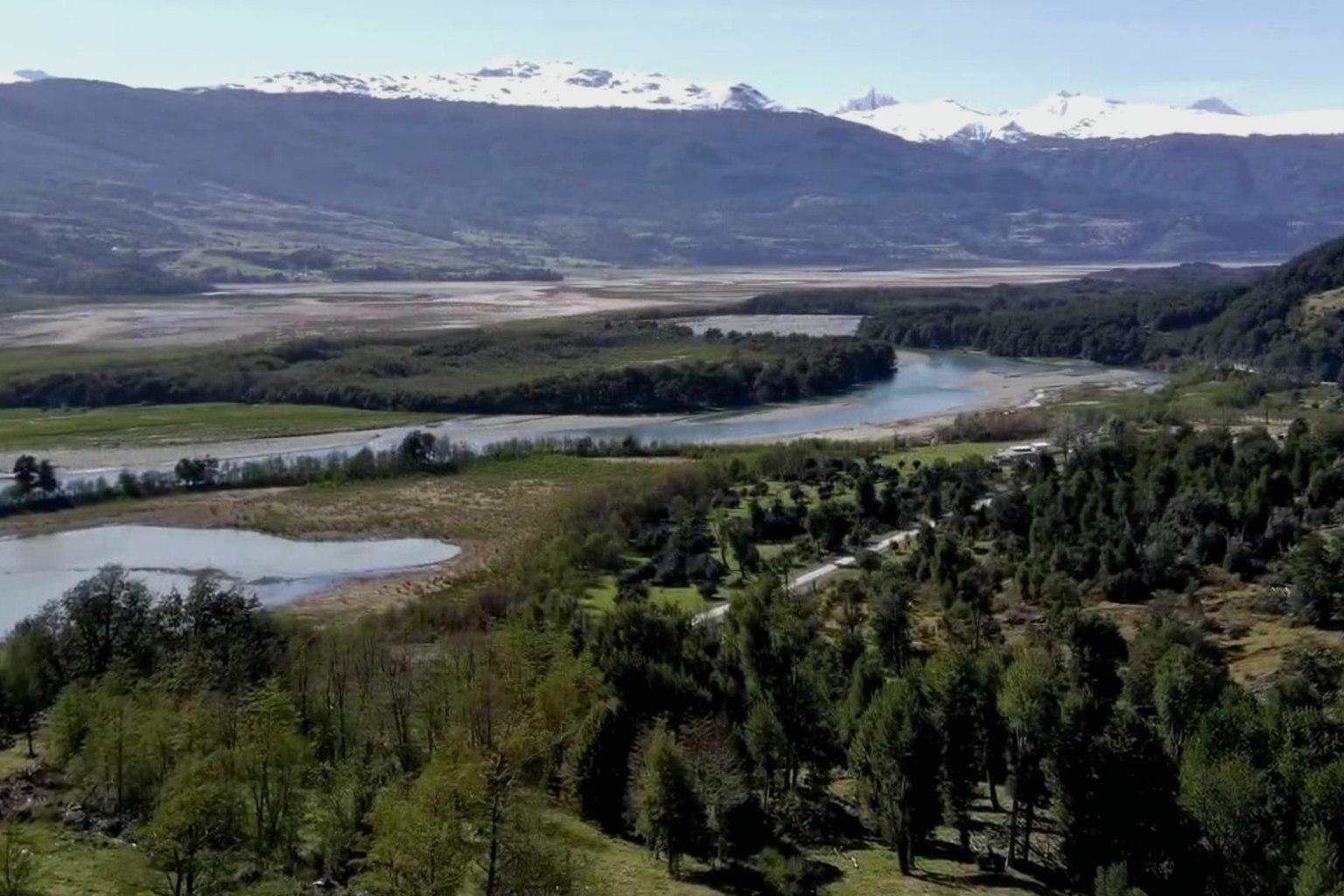 Preserve: a Patagonian valley, braided river and lake under the snowline.
